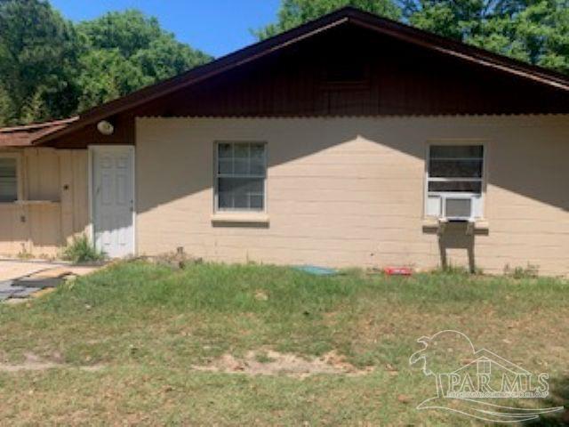 4165 Highway 87 Navarre, FL 32566 - Photo 3 of 4 a backyard of a house with lots of green space