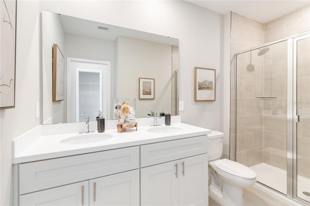 2442 Magnolia Reserve Road Ocoee, FL 34761 - Photo 15 of 24 a bathroom with a sink a toilet and shower