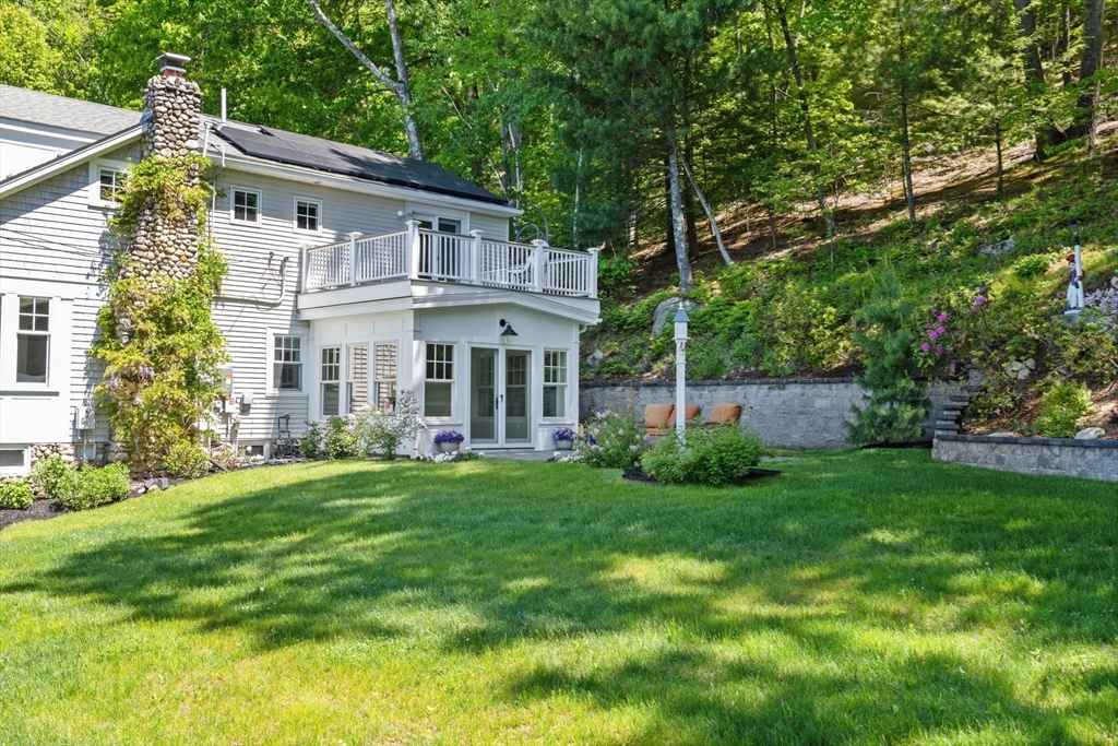 35 Keyes Road Westford, MA 01886 - Photo 39 of 40 a view of a house with a yard and sitting area