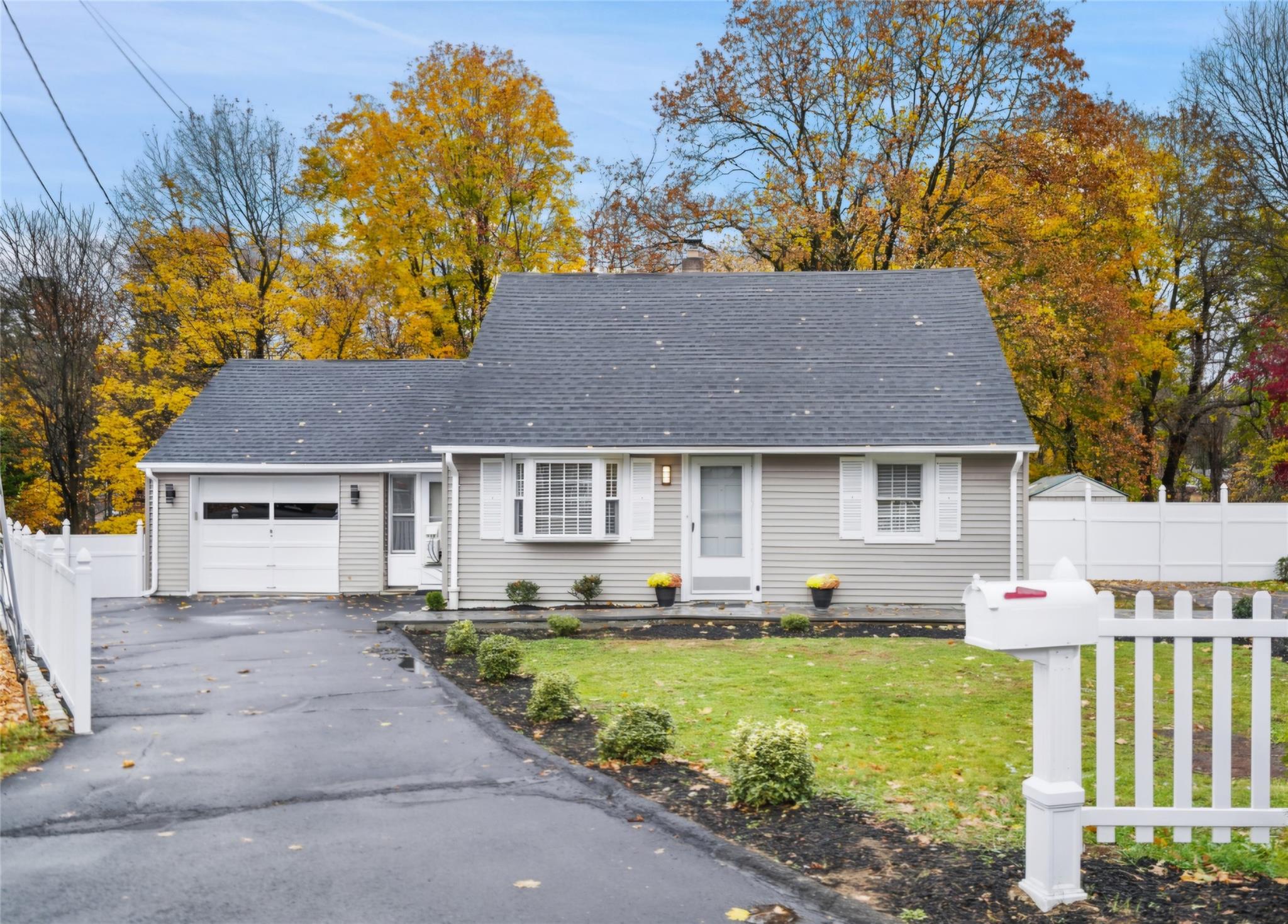 86 Old Barn Road West Stamford, CT 06905 - Photo 1 of 1 View of front facade featuring a garage and a front yard