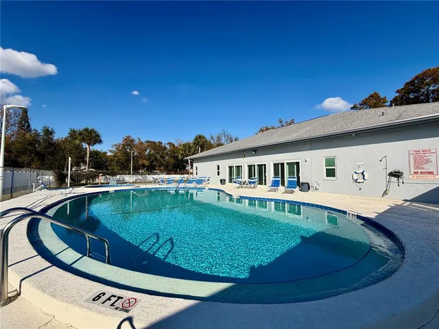 a view of a house with pool yard and outdoor seating
