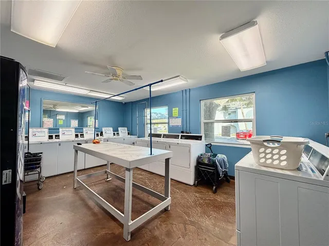 a room with furniture a rug and white walls