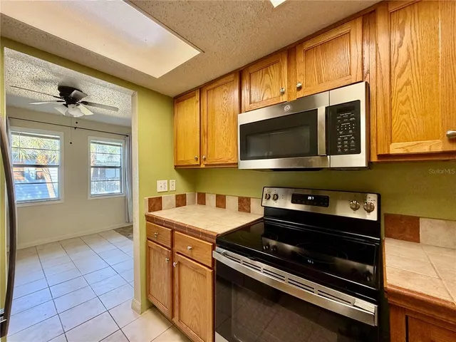a kitchen with stainless steel appliances a stove a sink and a microwave