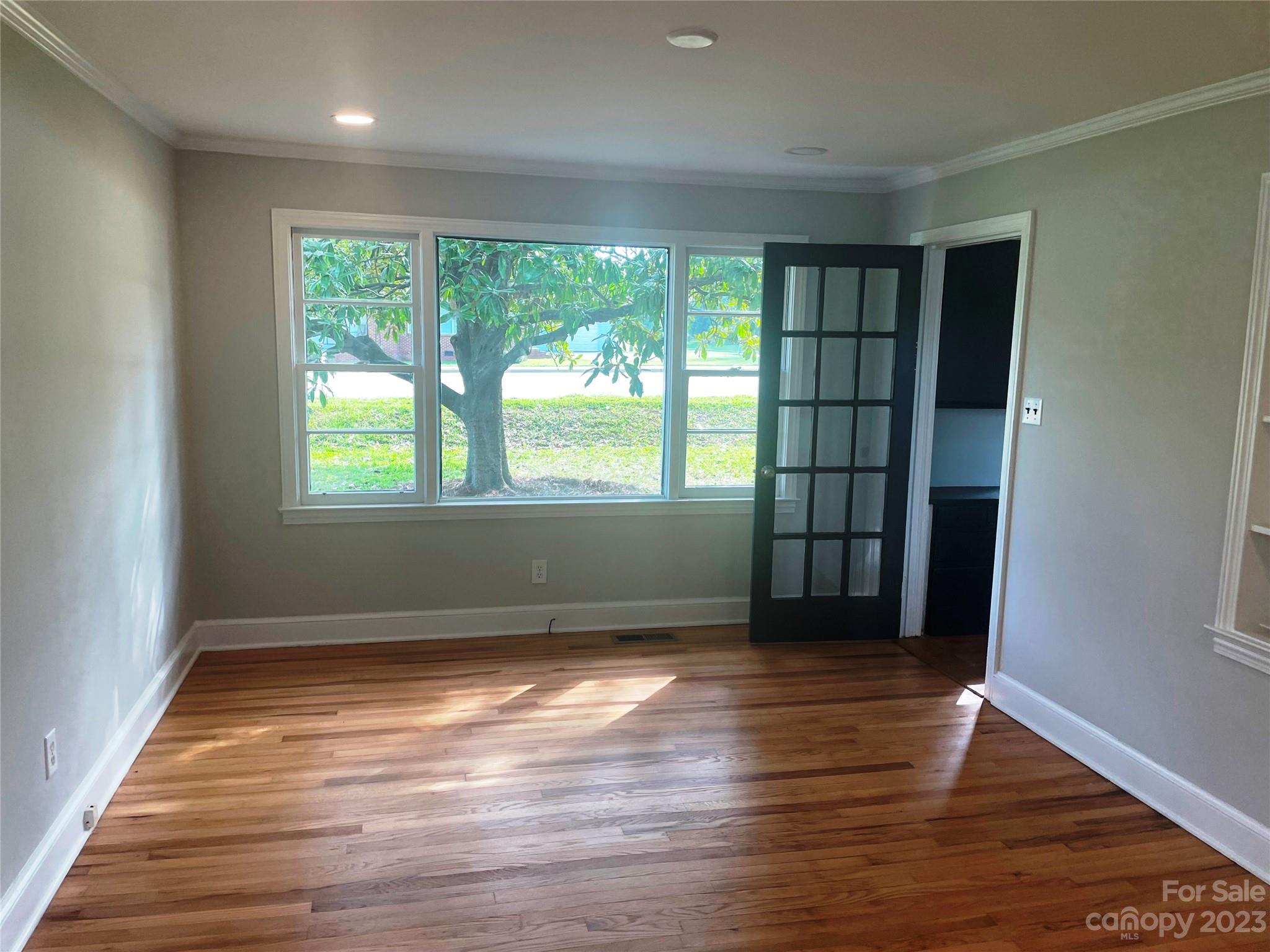 1607 Mt Gallant Road Rock Hill, SC 29732 - Photo 2 of 23 an empty room with wooden floor and windows