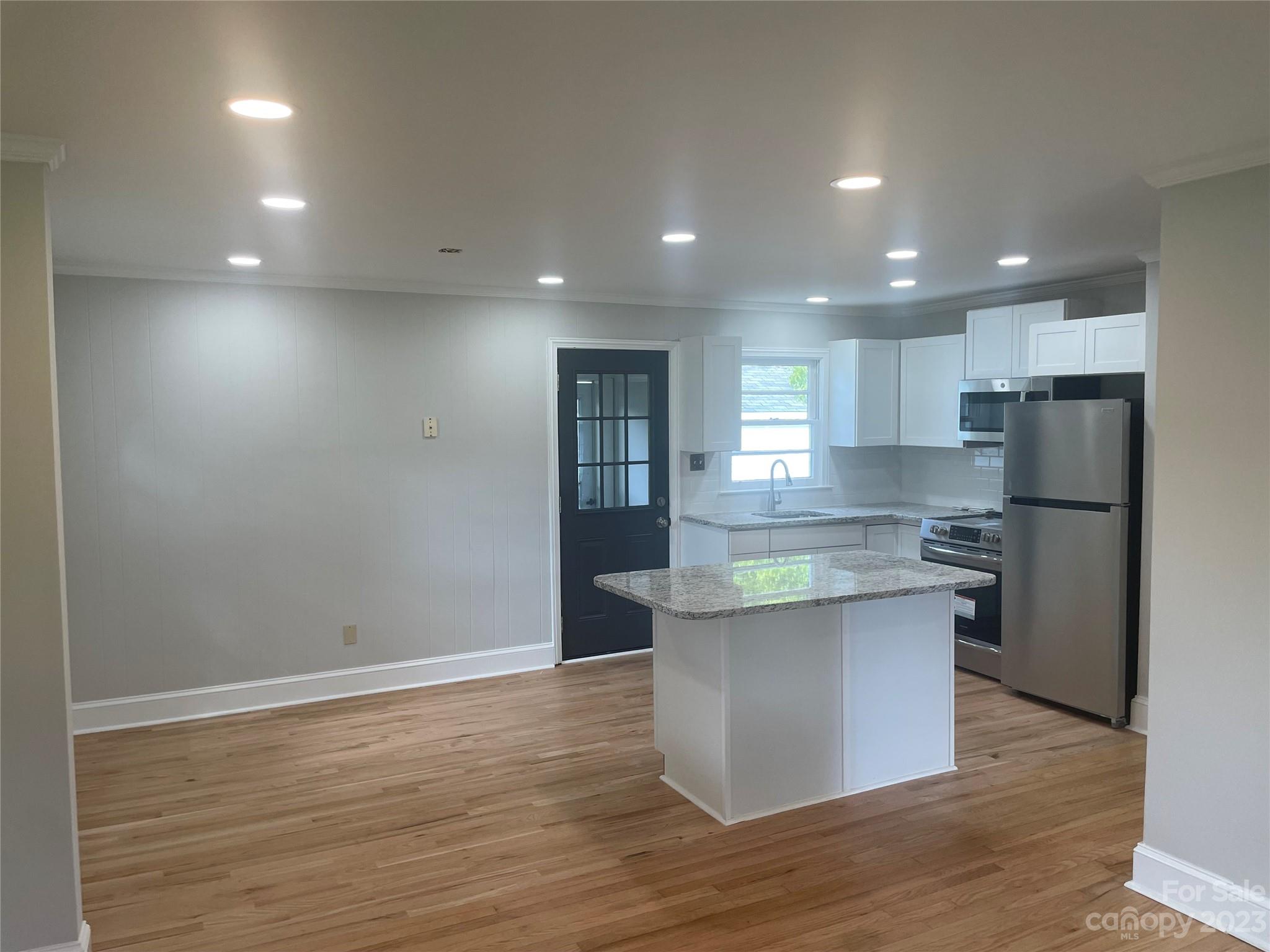 1607 Mt Gallant Road Rock Hill, SC 29732 - Photo 4 of 23 a kitchen with stainless steel appliances granite countertop a sink a stove a refrigerator and white cabinets