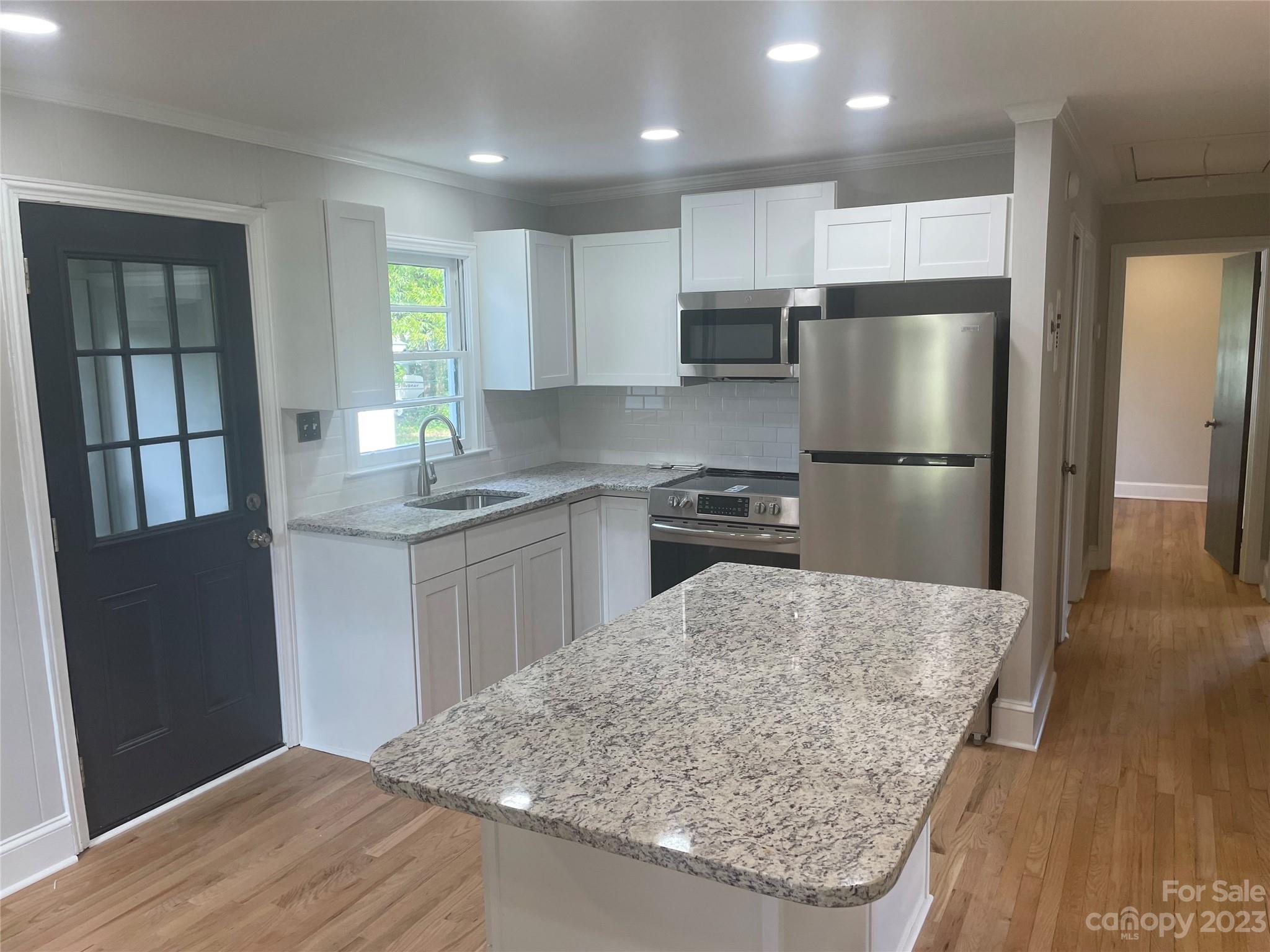 1607 Mt Gallant Road Rock Hill, SC 29732 - Photo 6 of 23 a kitchen with stainless steel appliances granite countertop a refrigerator a sink a stove a microwave and island