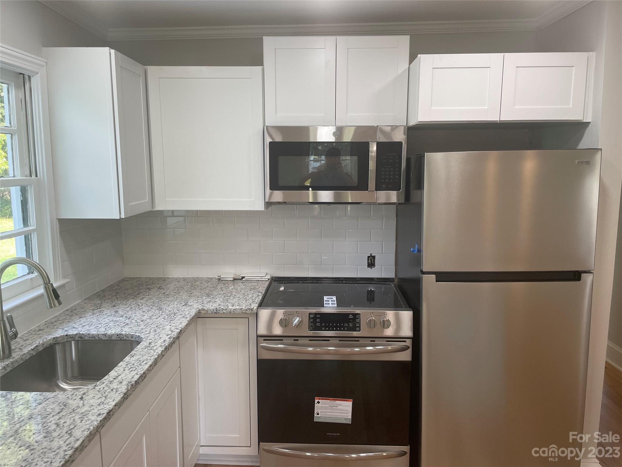 1607 Mt Gallant Road Rock Hill, SC 29732 - Photo 7 of 23 a kitchen with granite countertop a refrigerator sink and stove