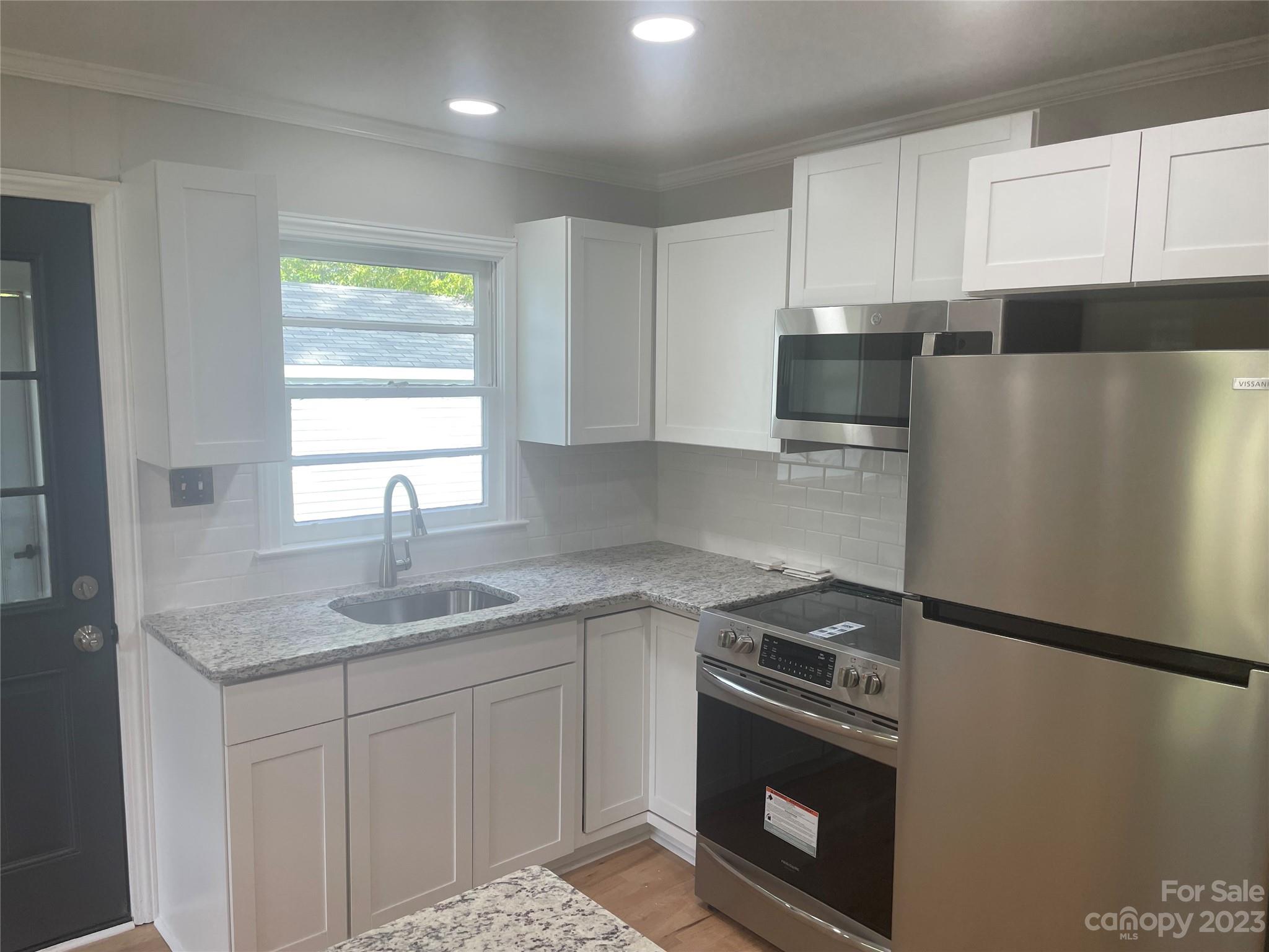 1607 Mt Gallant Road Rock Hill, SC 29732 - Photo 8 of 23 a kitchen with stainless steel appliances granite countertop a sink stove and refrigerator