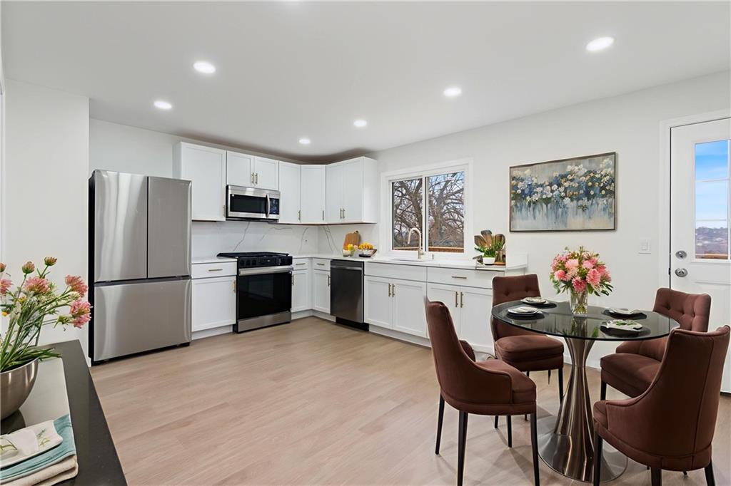 2441 Dewey Street Homestead, PA 15120 - Photo 6 of 27 a kitchen with white cabinets and stainless steel appliances