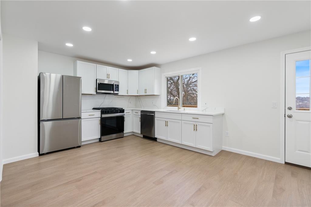 2441 Dewey Street Homestead, PA 15120 - Photo 7 of 27 a kitchen with white cabinets and white stainless steel appliances
