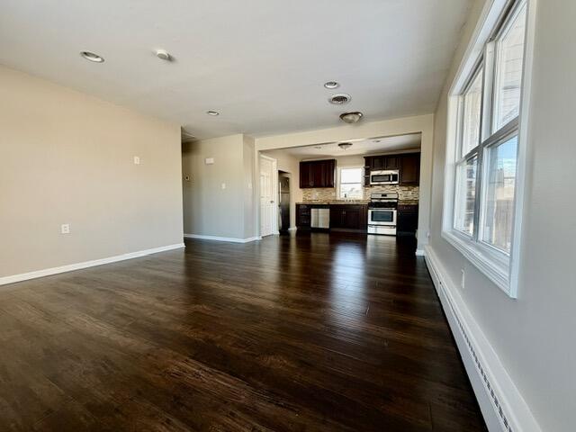 606 North Lindberg Street Griffith, IN 46319 - Photo 3 of 12 an empty room with wooden floor and a window