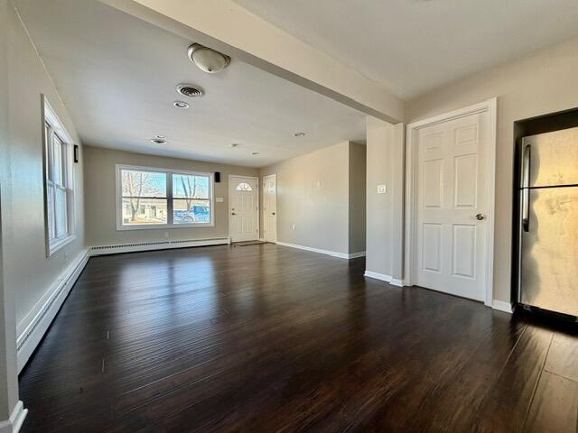 606 North Lindberg Street Griffith, IN 46319 - Photo 4 of 12 an empty room with wooden floor and windows