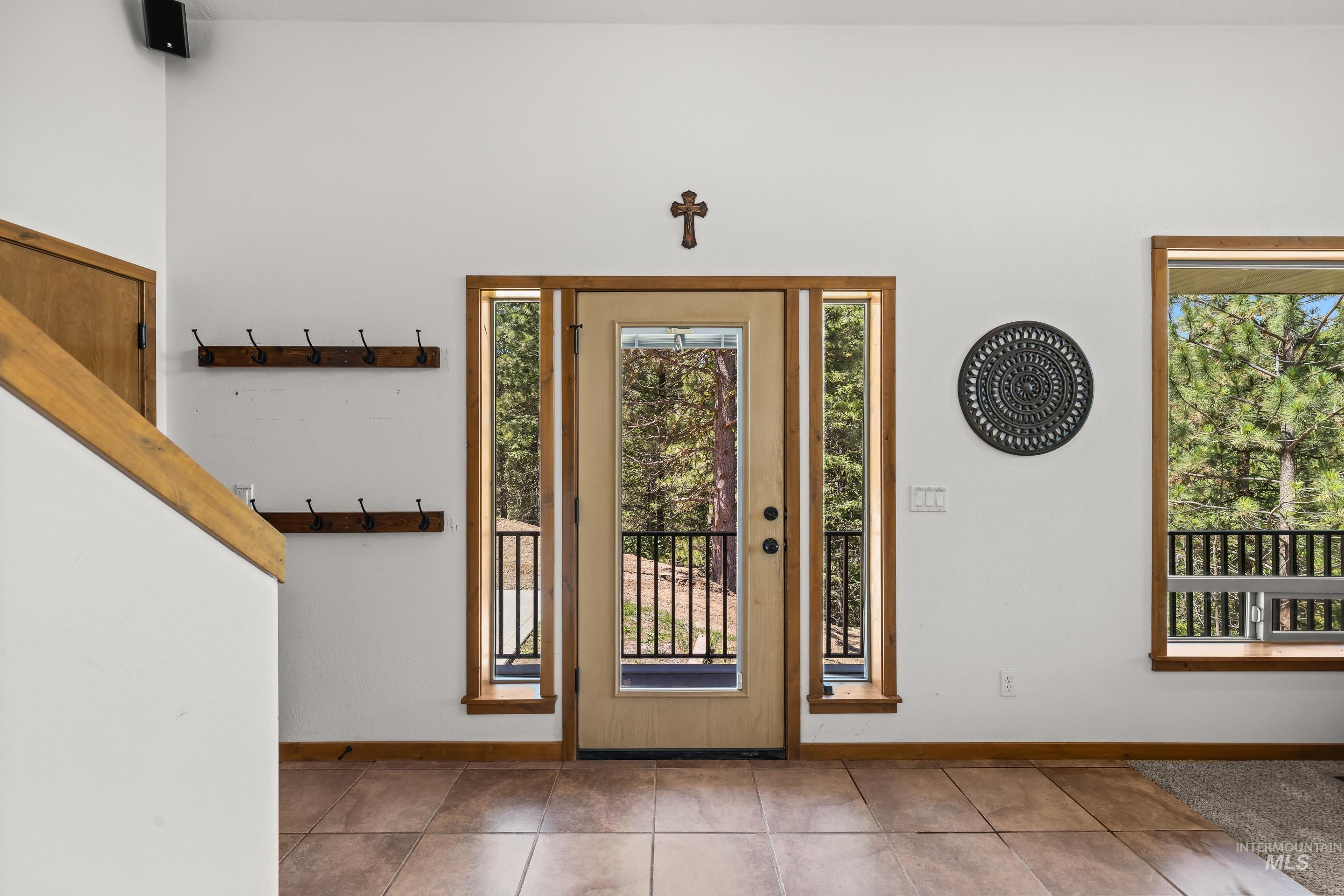 92 Cruickshank Road Horseshoe Bend, ID 83629 - Photo 4 of 50 Entryway featuring a full-light door with sidelights, wood-frame windows, and tile flooring