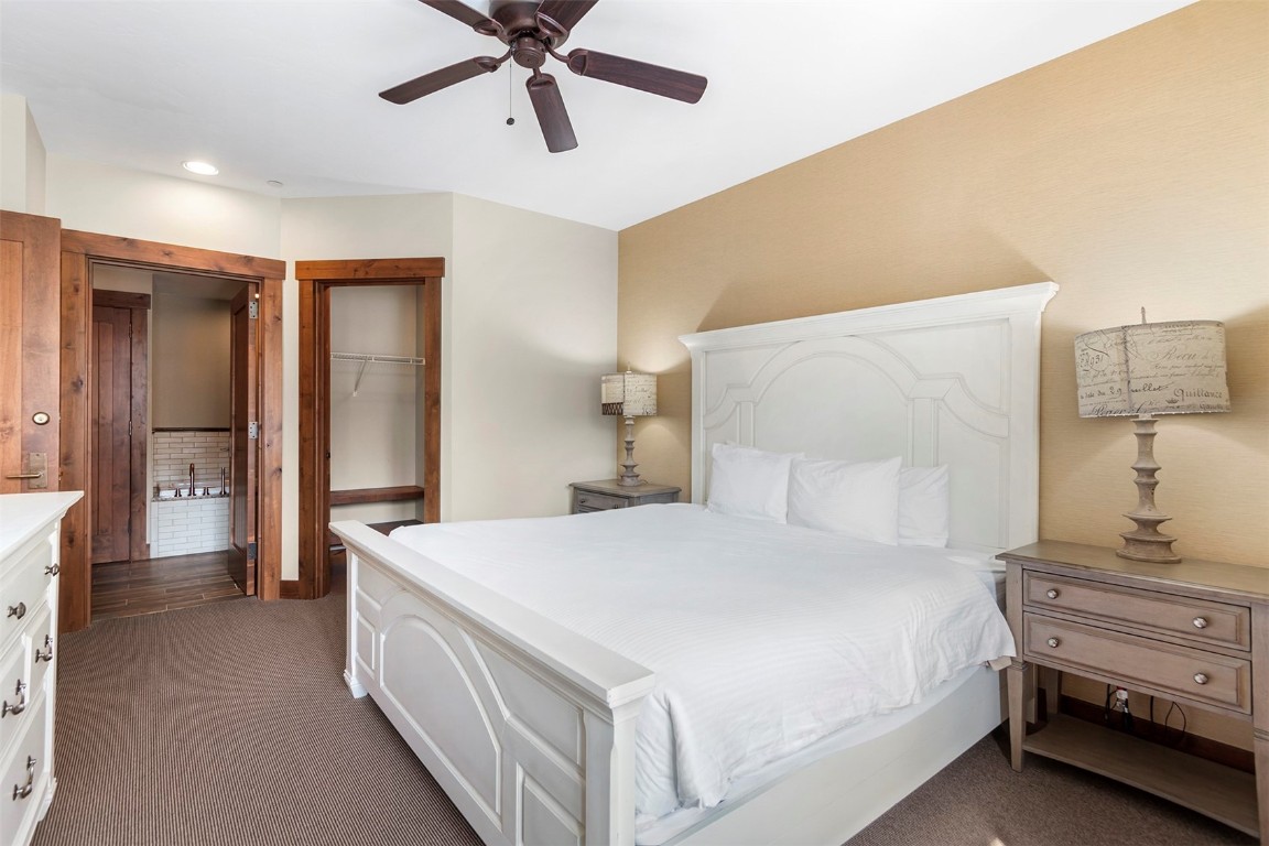 610 Columbine Road, Unit 6308 Breckenridge, CO 80424 - Photo 17 of 49 a bedroom with a bed and a chandelier