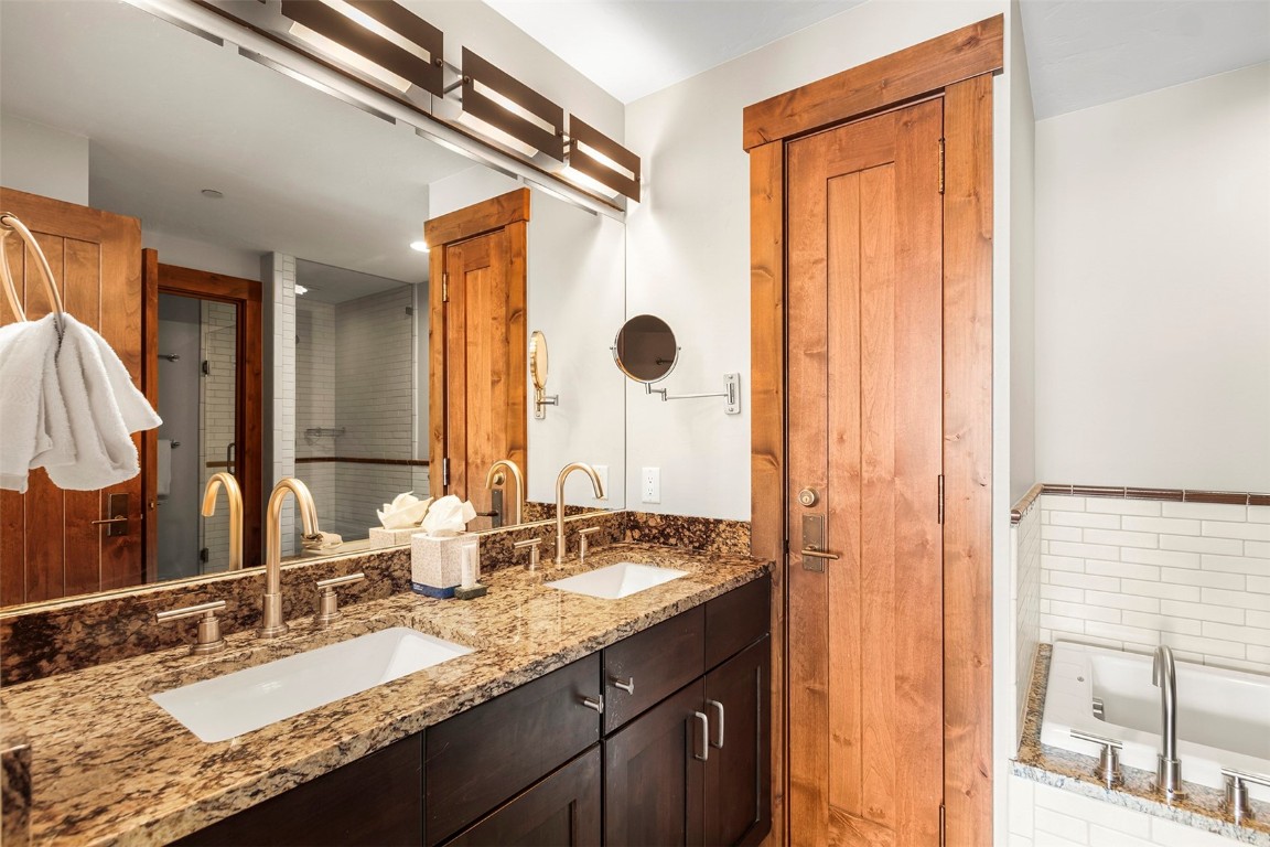 610 Columbine Road, Unit 6308 Breckenridge, CO 80424 - Photo 18 of 49 a bathroom with a granite countertop sink and a mirror
