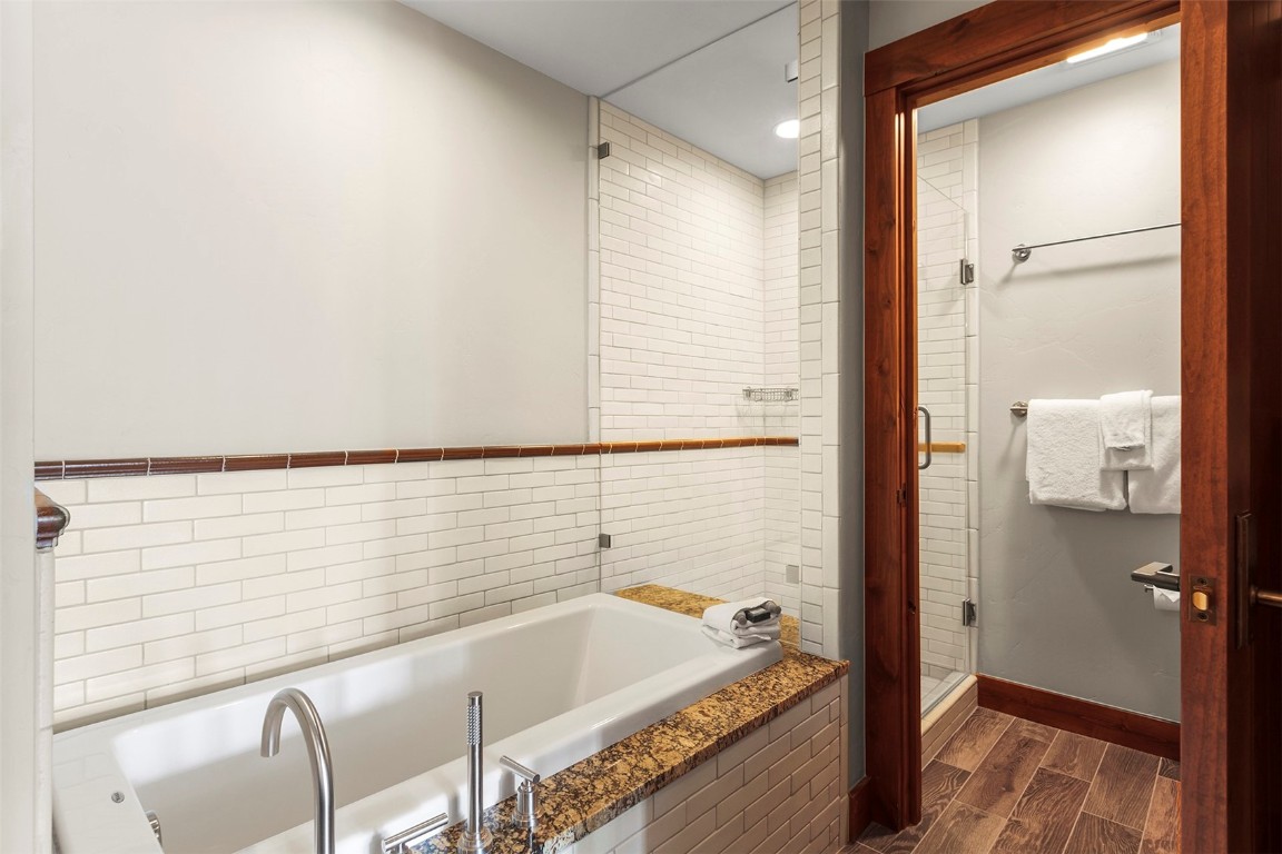 610 Columbine Road, Unit 6308 Breckenridge, CO 80424 - Photo 19 of 49 a bathroom with a tub and shower