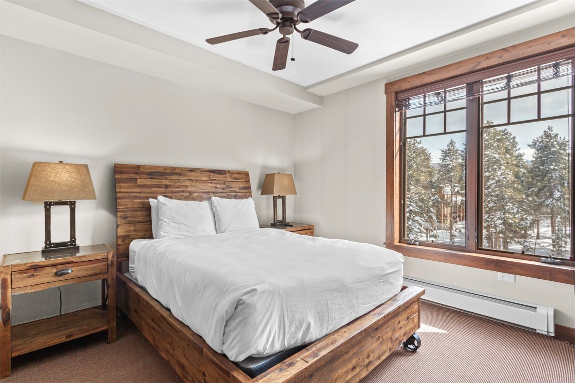 610 Columbine Road, Unit 6308 Breckenridge, CO 80424 - Photo 25 of 49 a bedroom with a large bed and a chandelier fan