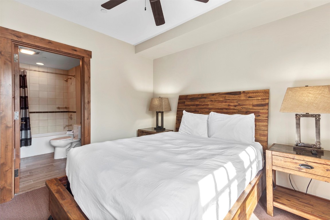 610 Columbine Road, Unit 6308 Breckenridge, CO 80424 - Photo 26 of 49 a bedroom with a bed and a lamp