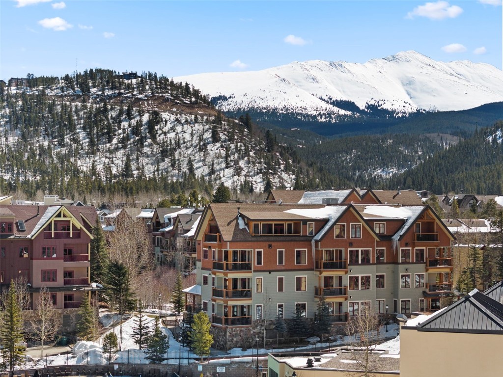 610 Columbine Road, Unit 6308 Breckenridge, CO 80424 - Photo 46 of 49 a front view of a residential apartment building with a yard