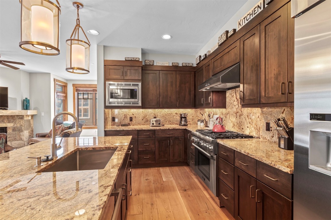 610 Columbine Road, Unit 6308 Breckenridge, CO 80424 - Photo 10 of 49 a large kitchen with stainless steel appliances granite countertop a sink stove and refrigerator