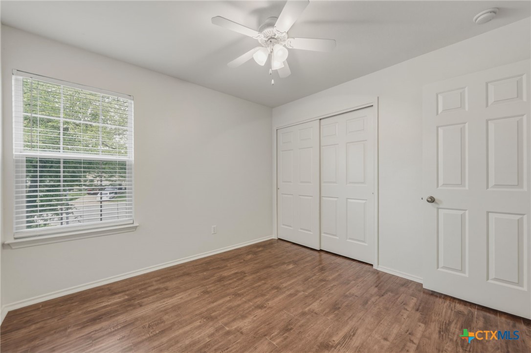 109 Comal Cove Elgin, TX 78621 - Photo 16 of 34 a view of an empty room with a window and a ceiling fan