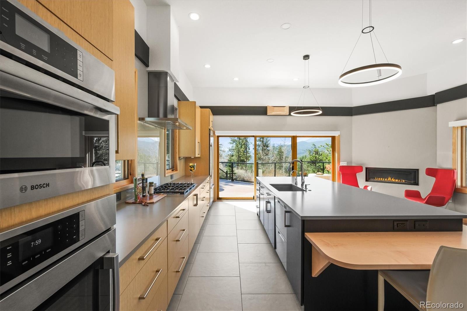682 Buddy Road Bailey, CO 80421 - Photo 12 of 50 a kitchen with stainless steel appliances granite countertop a sink and a microwave