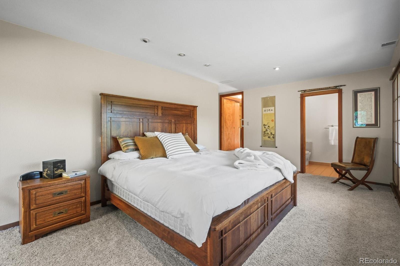 682 Buddy Road Bailey, CO 80421 - Photo 29 of 50 a bed room with a bed and a chair