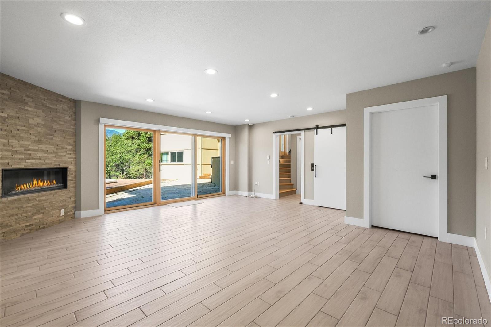 682 Buddy Road Bailey, CO 80421 - Photo 31 of 50 a view of an empty room with wooden floor and a window