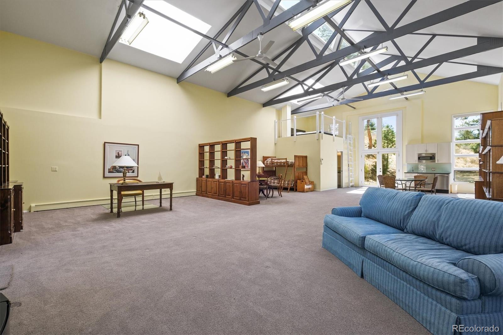 682 Buddy Road Bailey, CO 80421 - Photo 41 of 50 a living room with furniture and a chandelier
