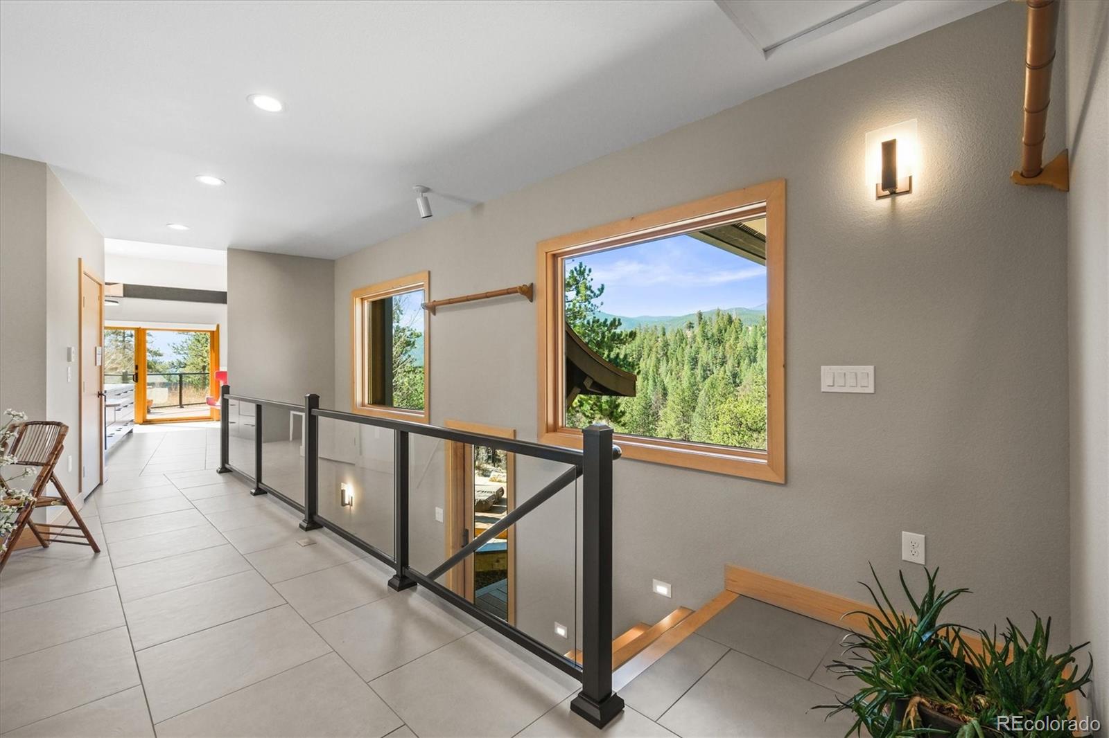 682 Buddy Road Bailey, CO 80421 - Photo 6 of 50 a view of a hallway with furniture and windows