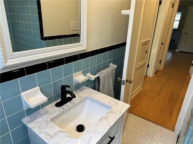 a bathroom with a sink a toilet and a mirror