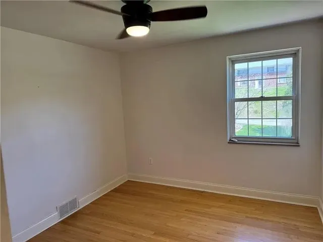 a view of a room with a chandelier fan and closet