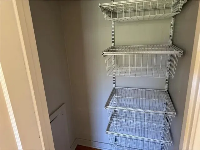 a white toilet sitting next to a sink and vanity