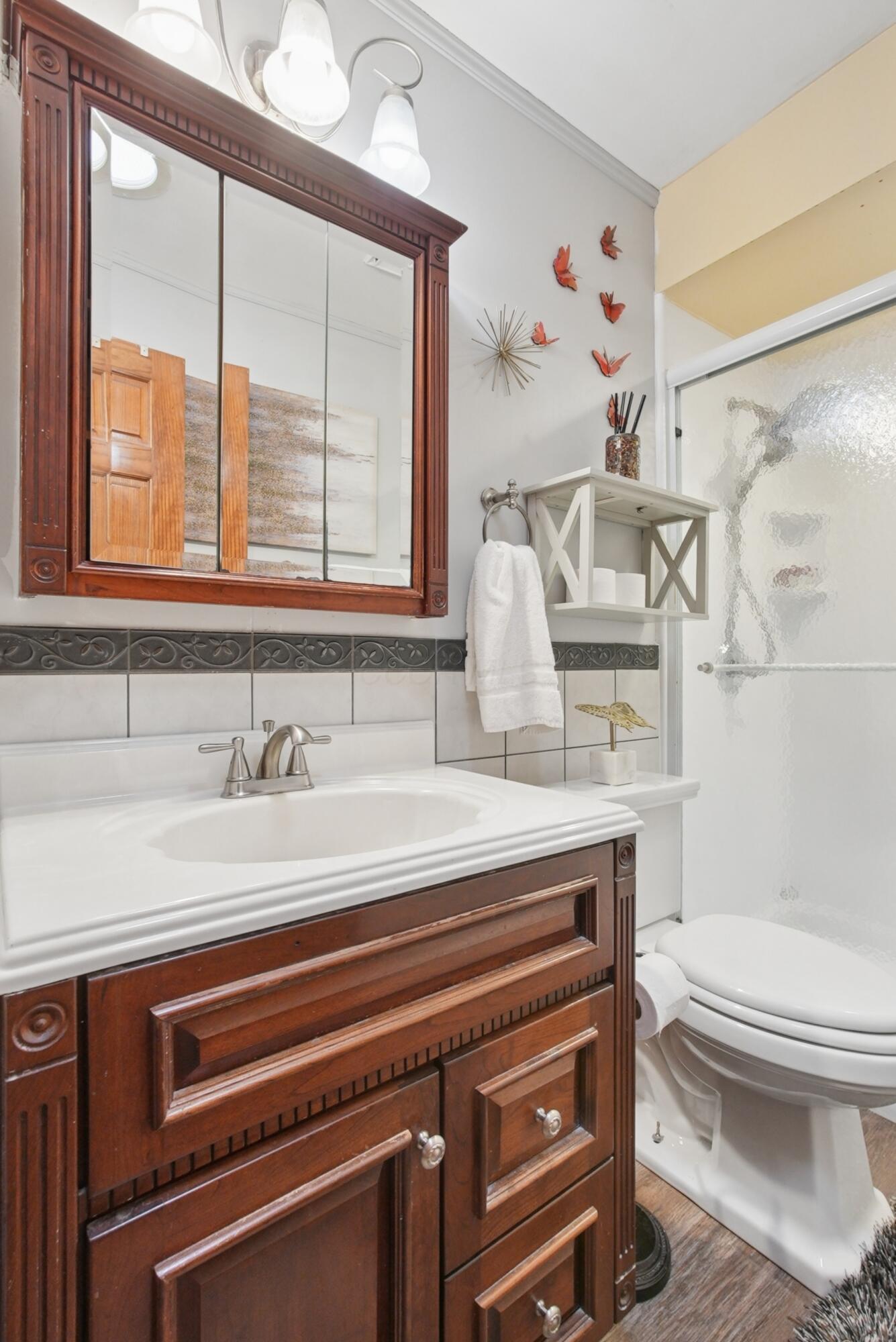 1636 Courtright Road Columbus, OH 43227 - Photo 20 of 35 Rich wood-finish vanity with a white countertop and integrated sink