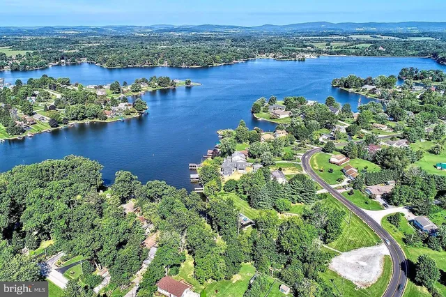 an aerial view of a houses with a lake view