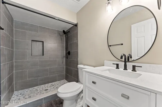 a bathroom with a sink toilet and a mirror