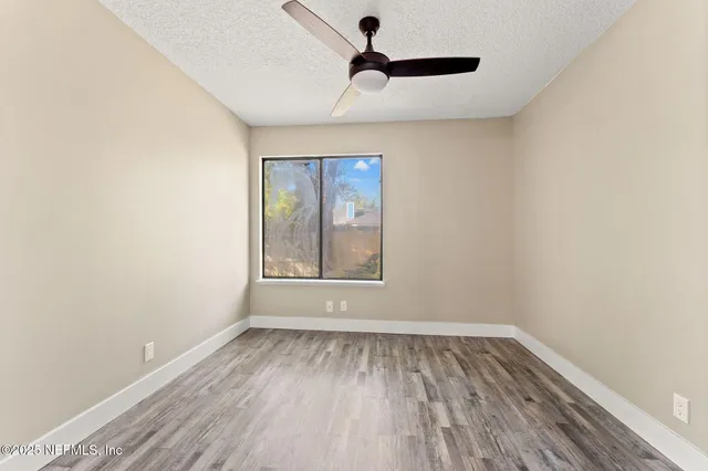 a view of room with window and hardwood floor