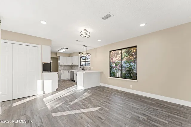 a view of a kitchen with a sink and a window