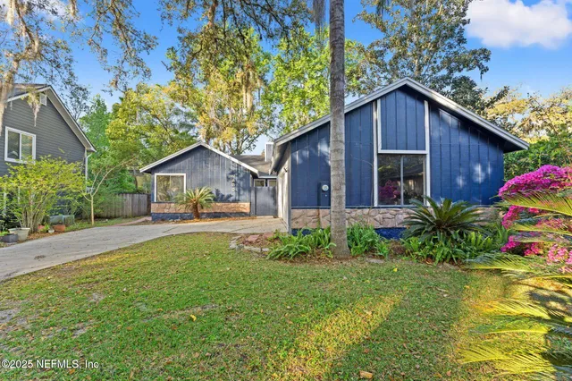 a front view of house with yard and green space