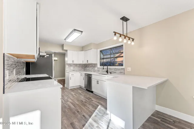 a kitchen with a sink a stove and refrigerator