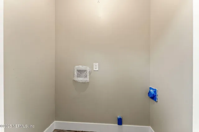 a bathroom with a white wall