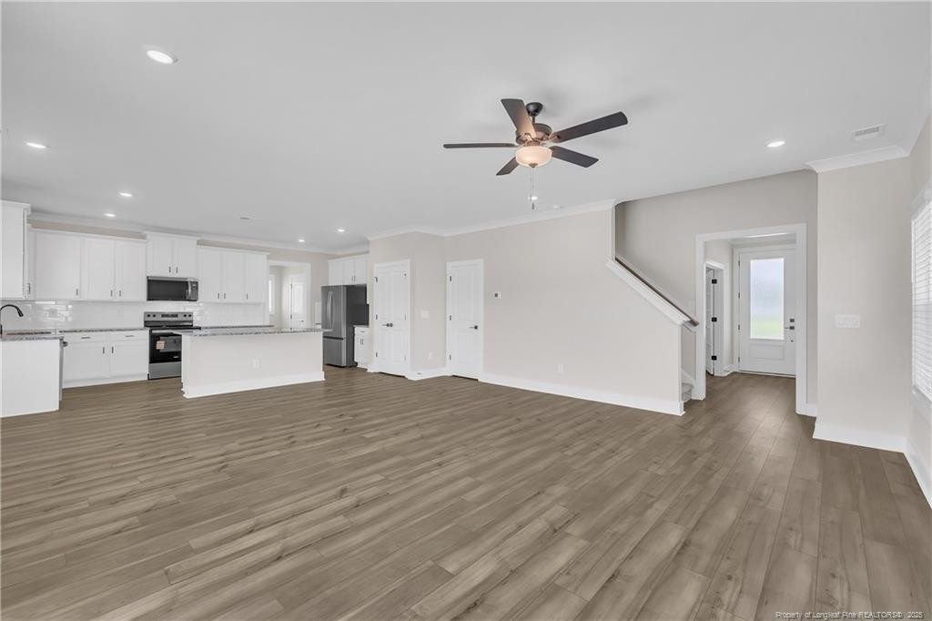 136 Camp Rock Road Lillington, NC 27546 - Photo 11 of 43 a view of an empty room with wooden floor kitchen view and a window