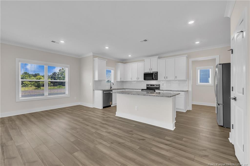 136 Camp Rock Road Lillington, NC 27546 - Photo 12 of 43 a kitchen with stainless steel appliances granite countertop a refrigerator sink and cabinets