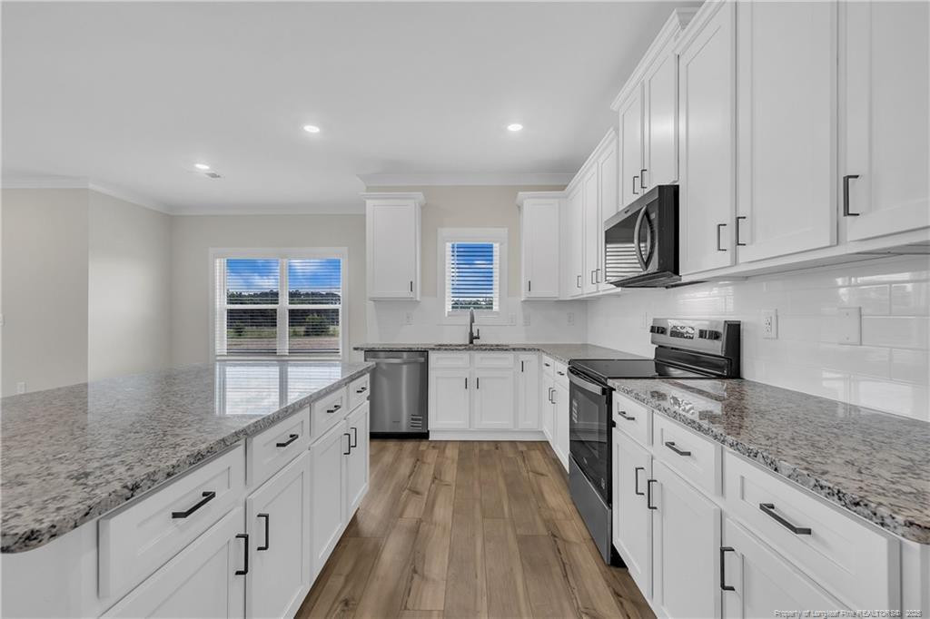 136 Camp Rock Road Lillington, NC 27546 - Photo 16 of 43 a large kitchen with stainless steel appliances granite countertop a lot of counter space and a sink