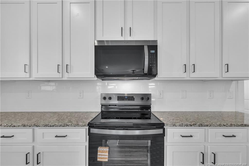 136 Camp Rock Road Lillington, NC 27546 - Photo 17 of 43 a stove top oven sitting inside of a kitchen