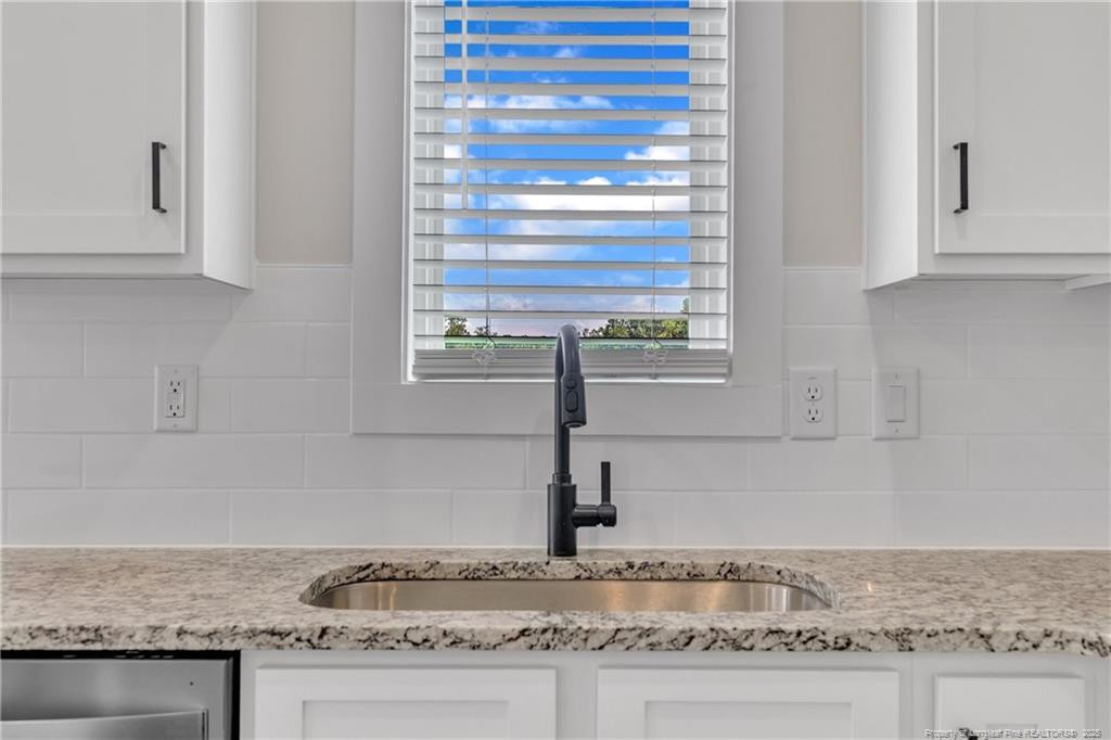 136 Camp Rock Road Lillington, NC 27546 - Photo 19 of 43 a kitchen with granite countertop window and cabinets