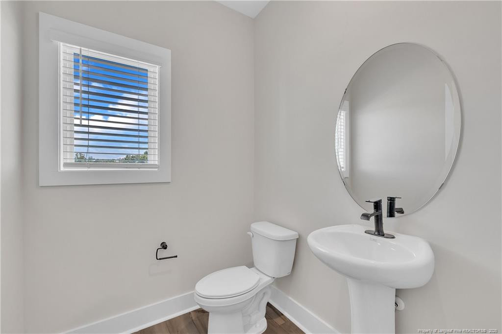 136 Camp Rock Road Lillington, NC 27546 - Photo 21 of 43 a bathroom with a sink a mirror and a toilet