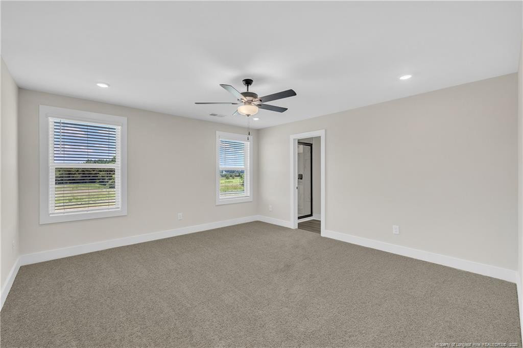136 Camp Rock Road Lillington, NC 27546 - Photo 22 of 43 an empty room with windows and ceiling fan