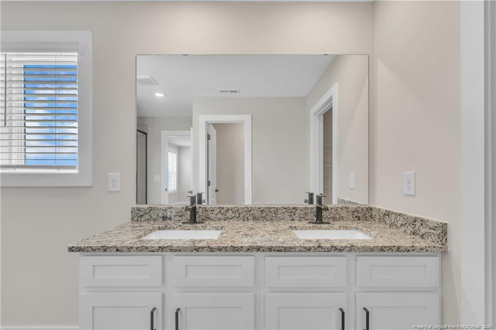 136 Camp Rock Road Lillington, NC 27546 - Photo 26 of 43 a bathroom with a granite countertop sink and a mirror