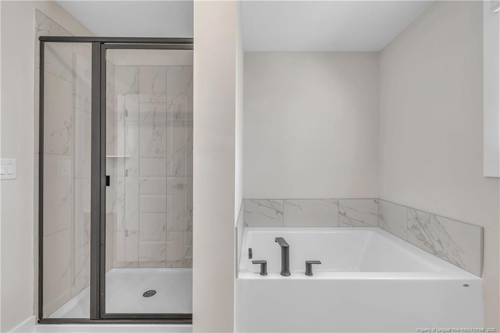 136 Camp Rock Road Lillington, NC 27546 - Photo 27 of 43 a bathroom with a tub and shower